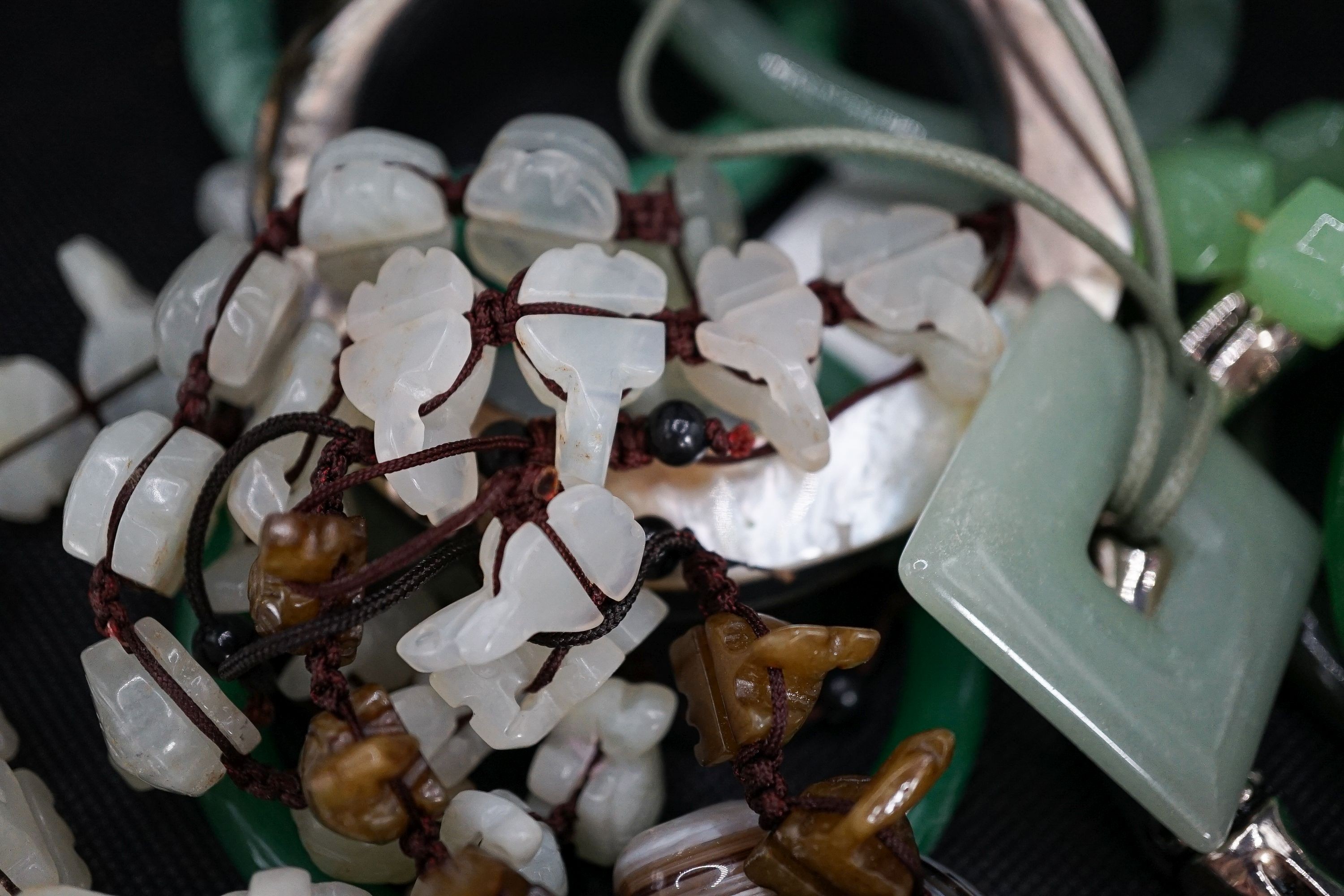A group of bangles and necklaces including jade and agate.